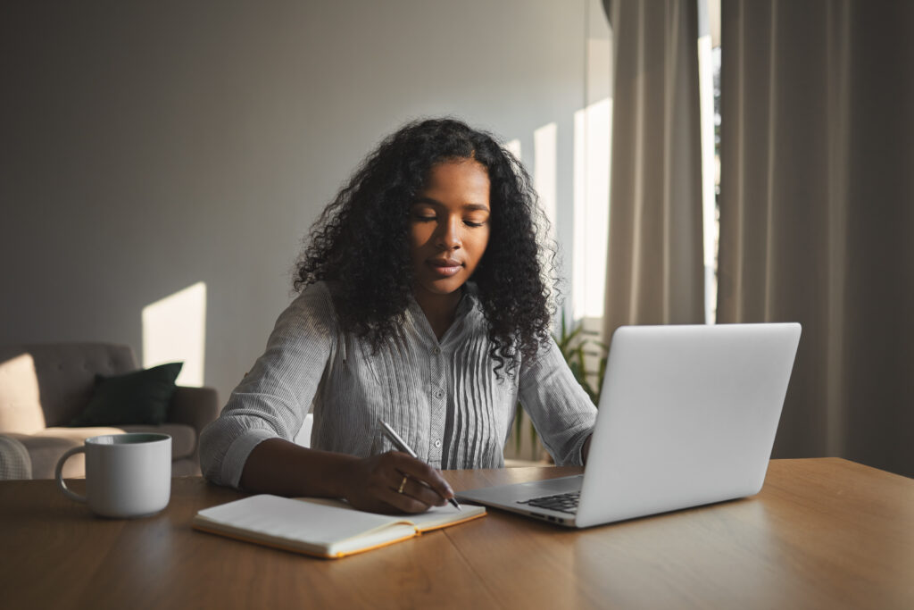 Young woman writing a cover letter for a teaching job in the US.
